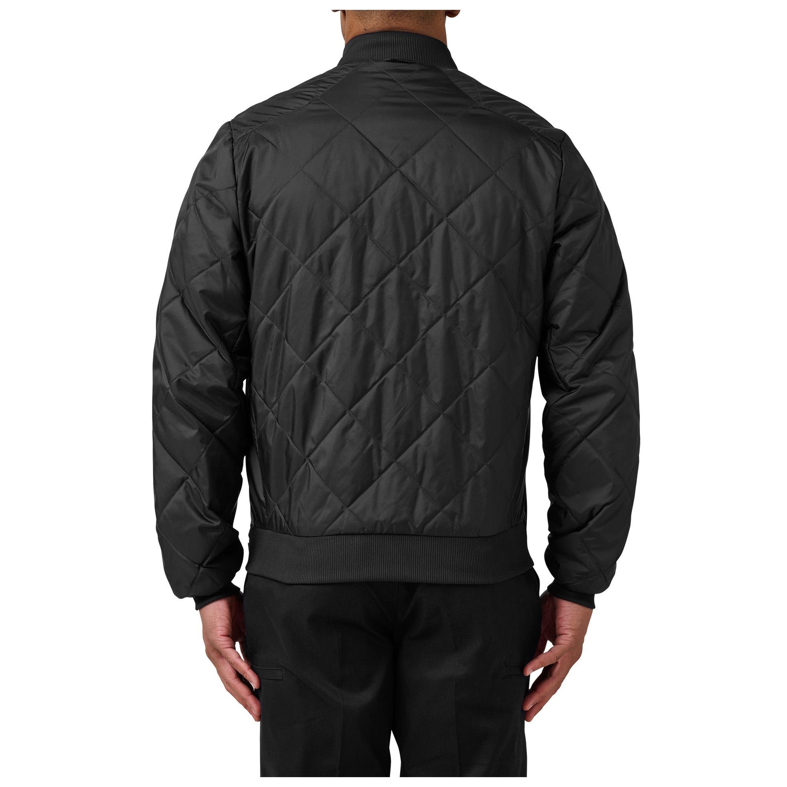Black quilted jacket worn by a person on a white background