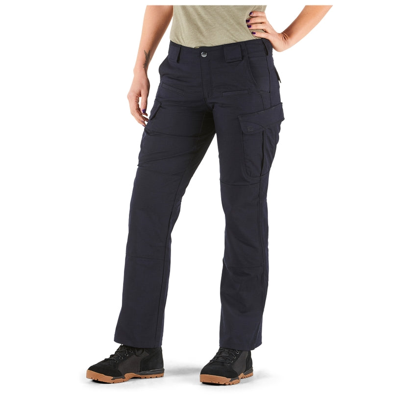 Person wearing navy blue tactical pants on a white background