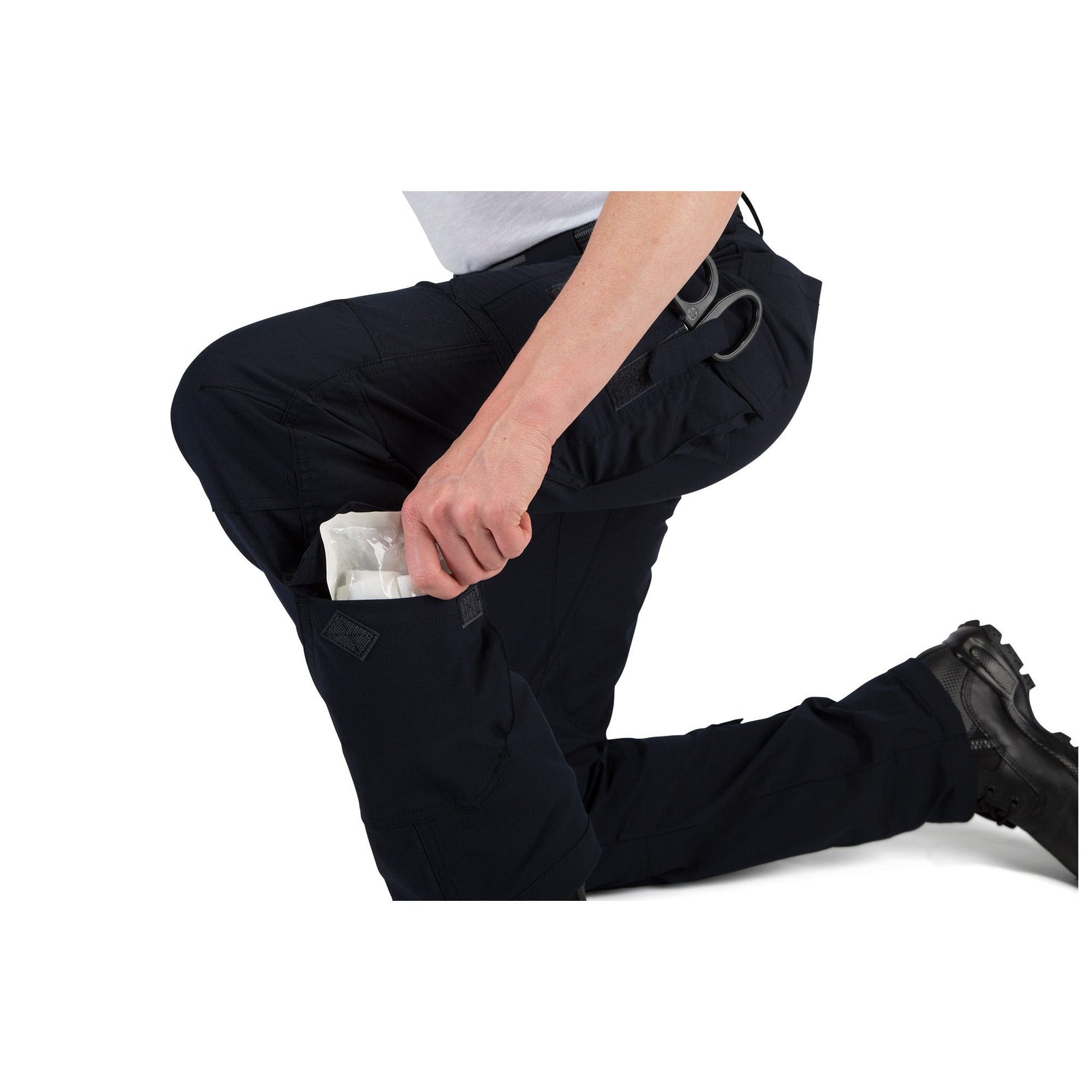 Person wearing black pants with a visible pocket on a white background