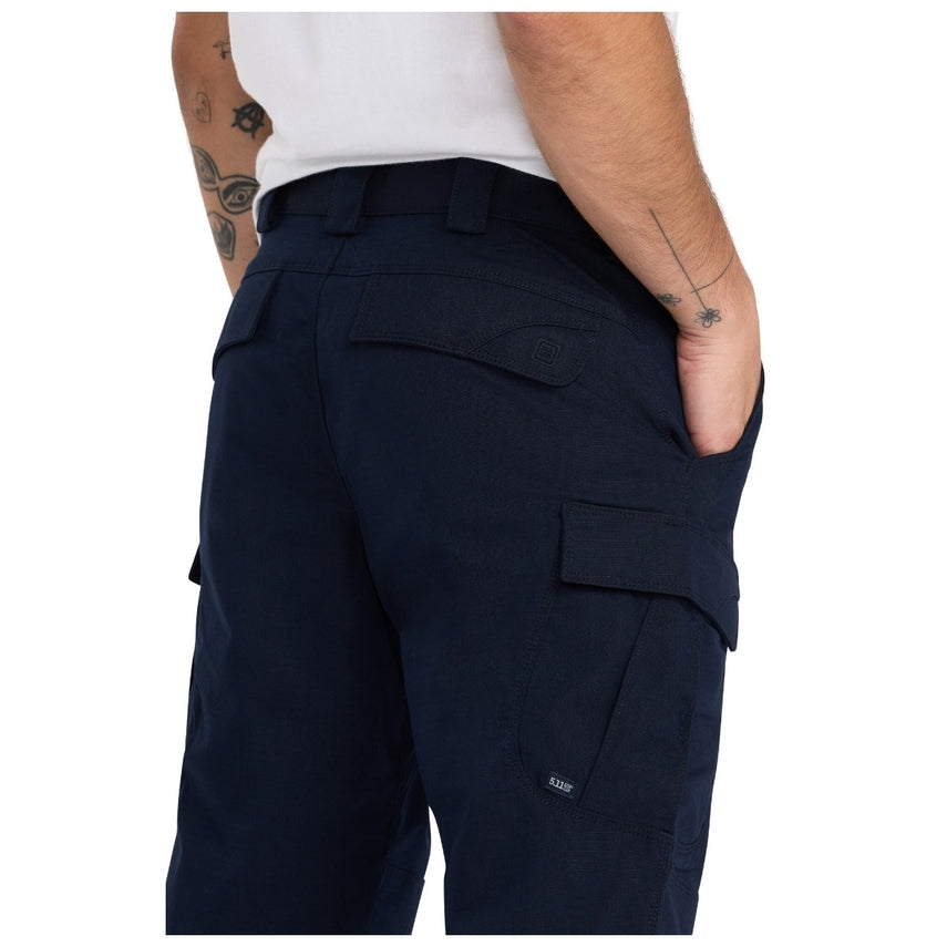 Navy cargo shorts worn by a person on a white background