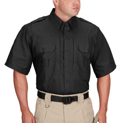 Person wearing a black short-sleeve shirt and beige pants on a white background