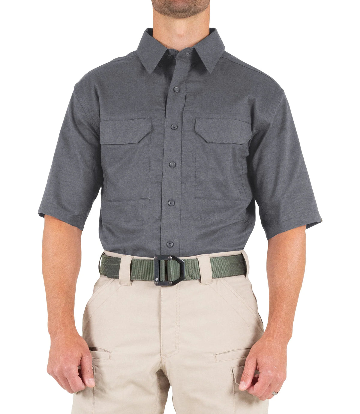 Person wearing a gray short-sleeve shirt with pockets and beige pants on a white background