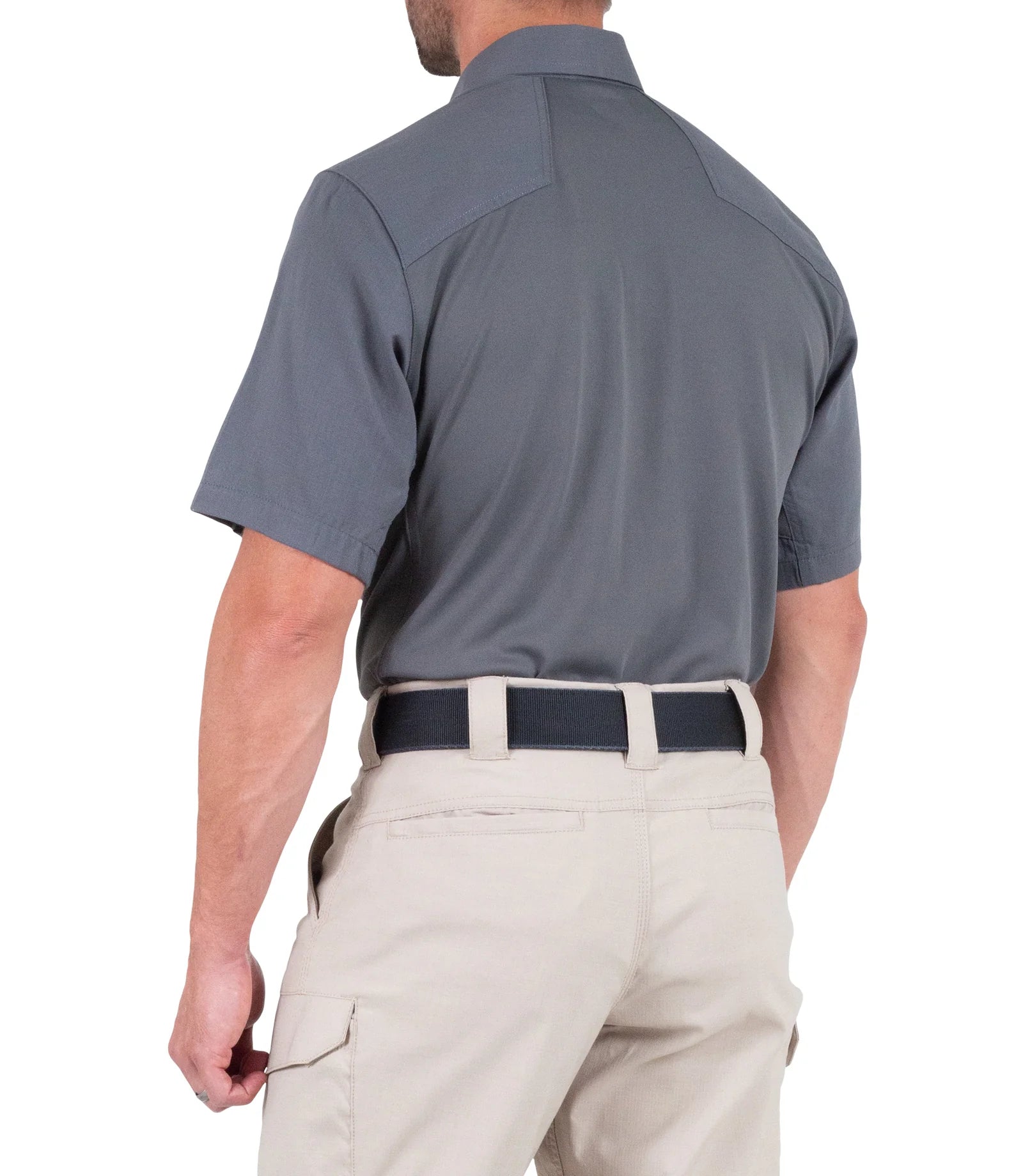 Man wearing a gray short-sleeve shirt and beige pants on a white background