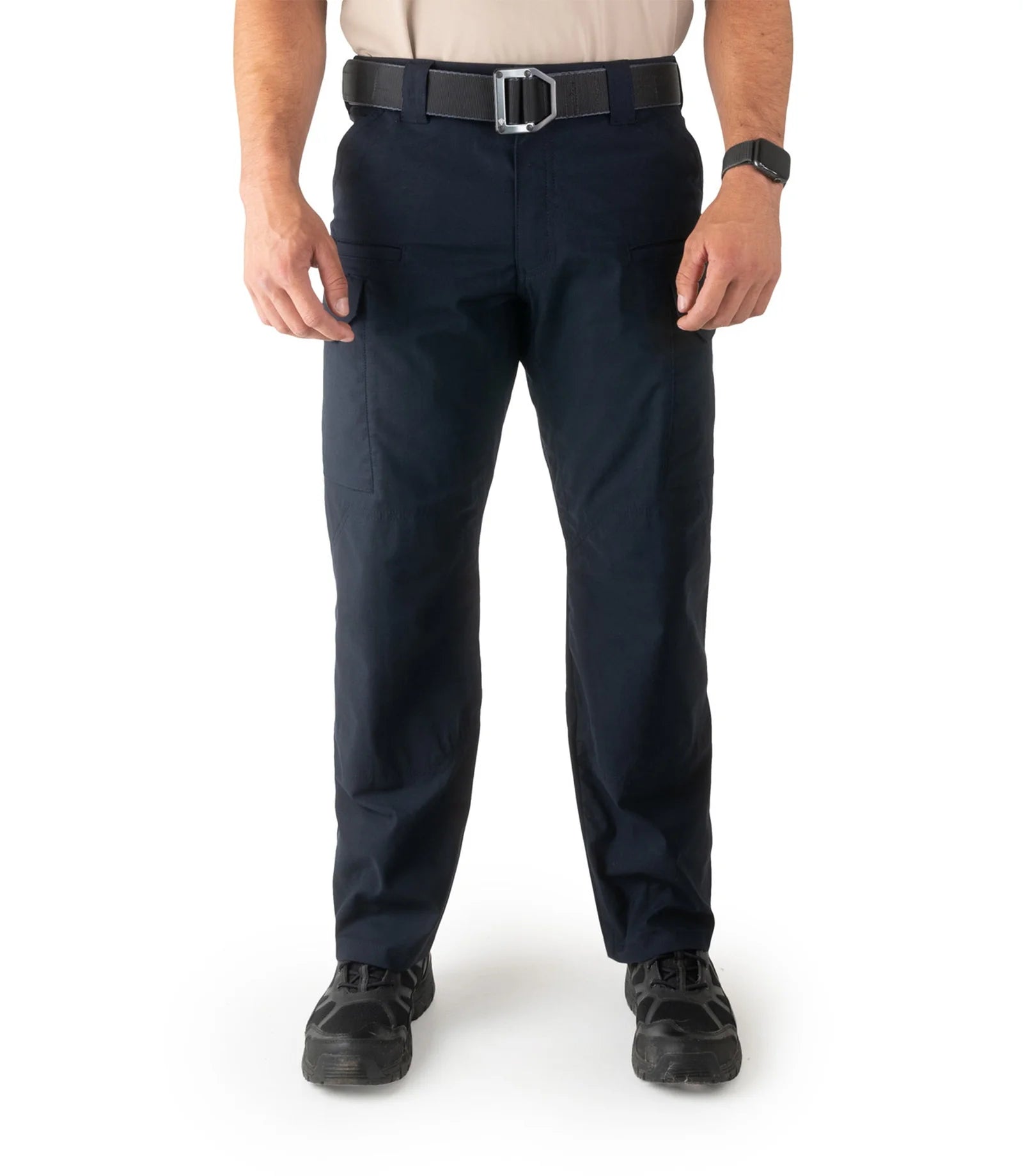 Person wearing navy pants with a belt on a white background