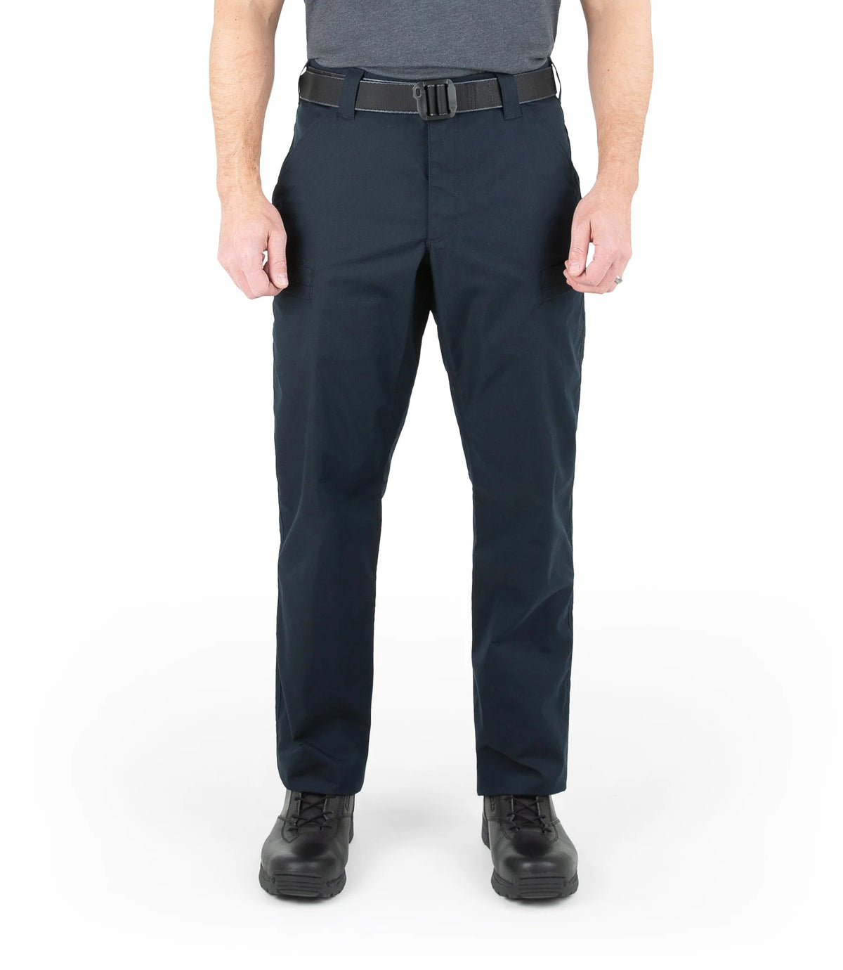 Person wearing navy pants with a gray belt on a white background