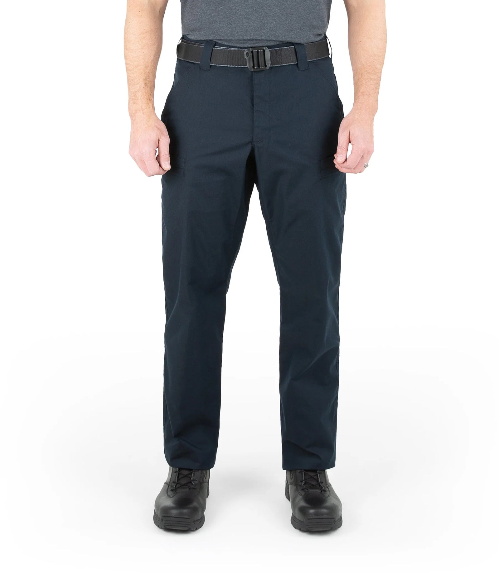 Person wearing navy pants with a gray belt on a white background