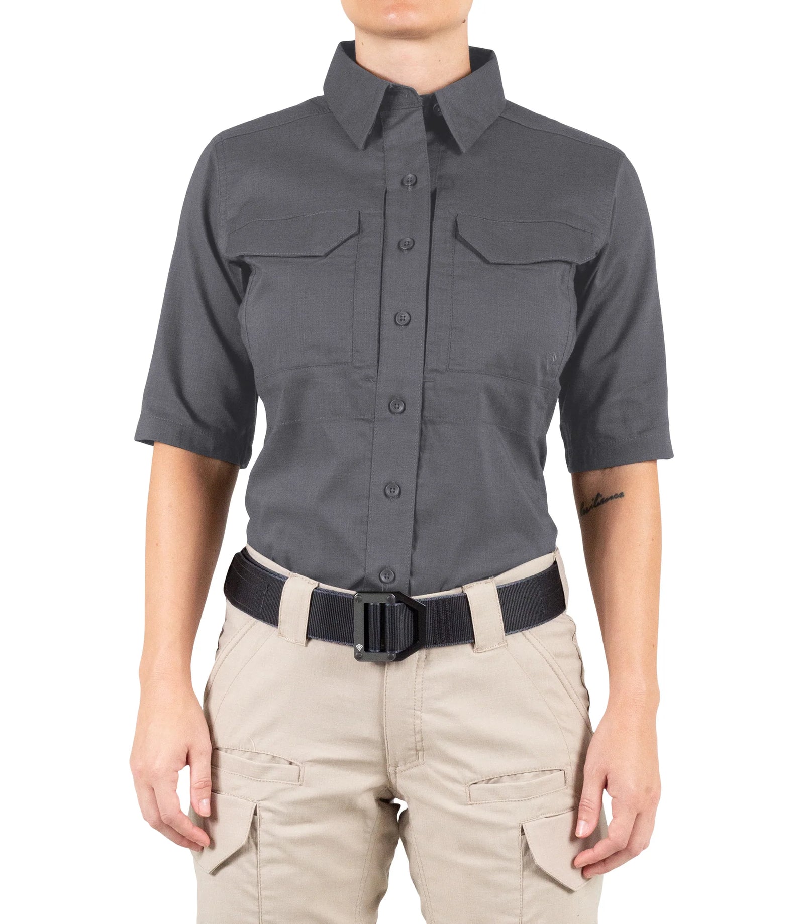 Person wearing a gray short-sleeve shirt and beige pants on a white background