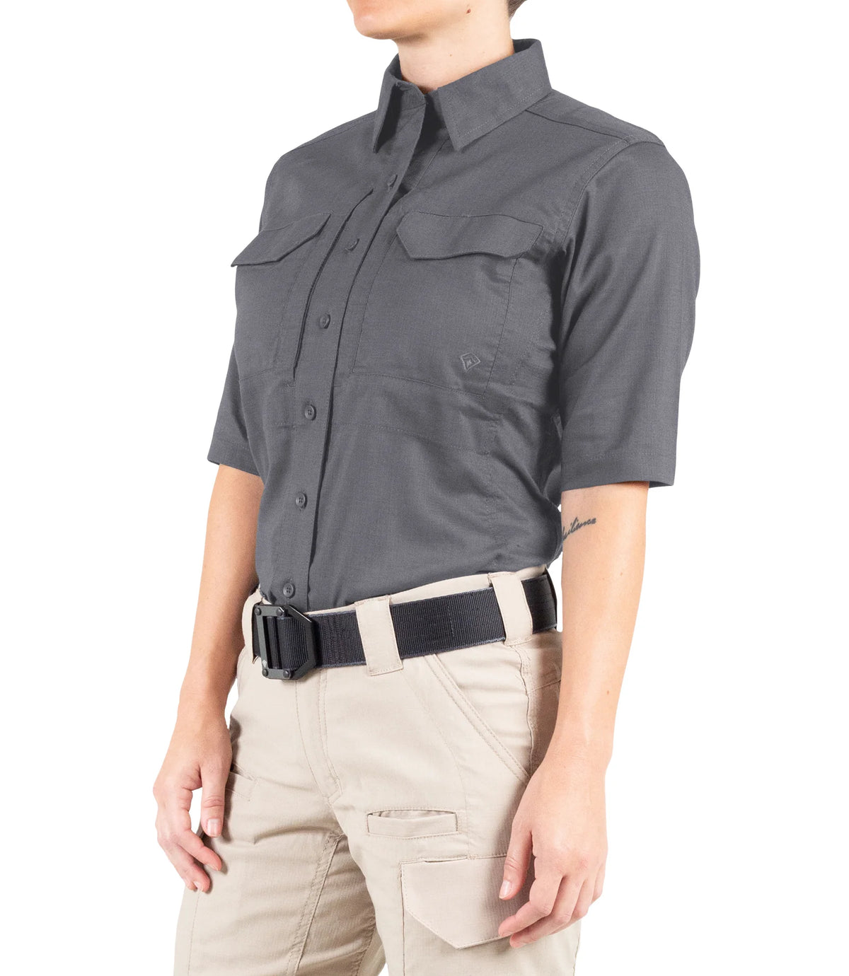 Person wearing a gray short-sleeve shirt and beige pants on a white background
