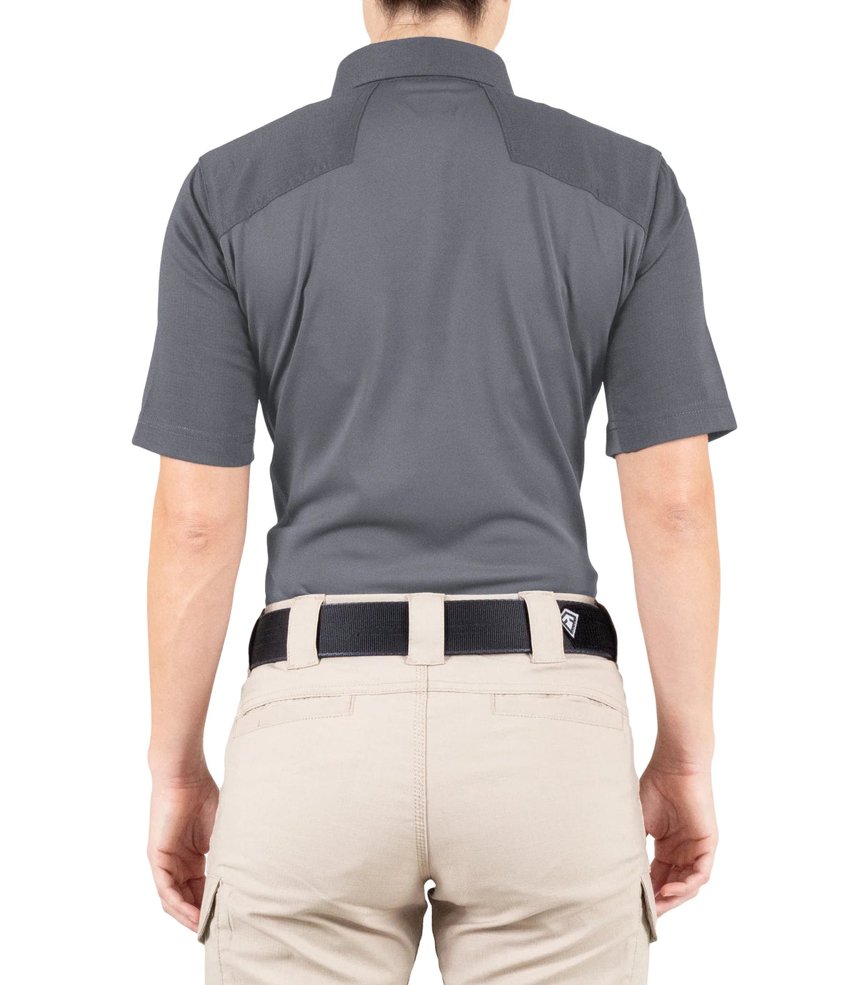 Person wearing a gray polo shirt and beige pants on a white background