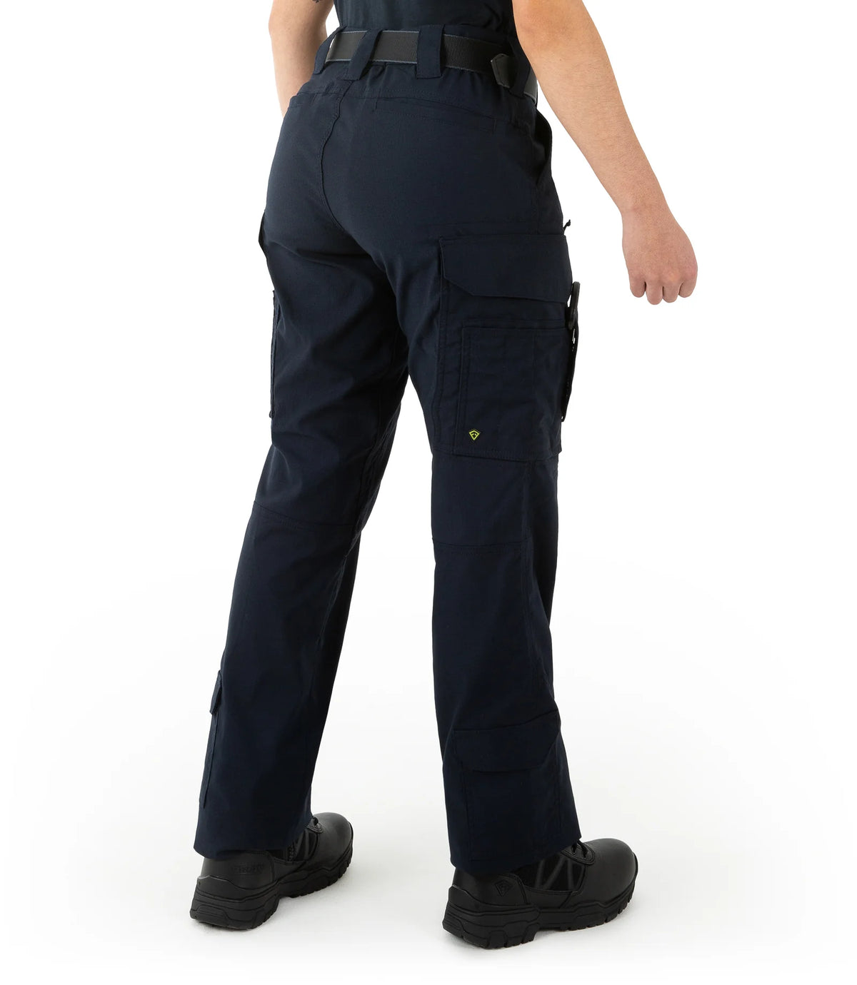 Person wearing navy blue tactical pants on a white background