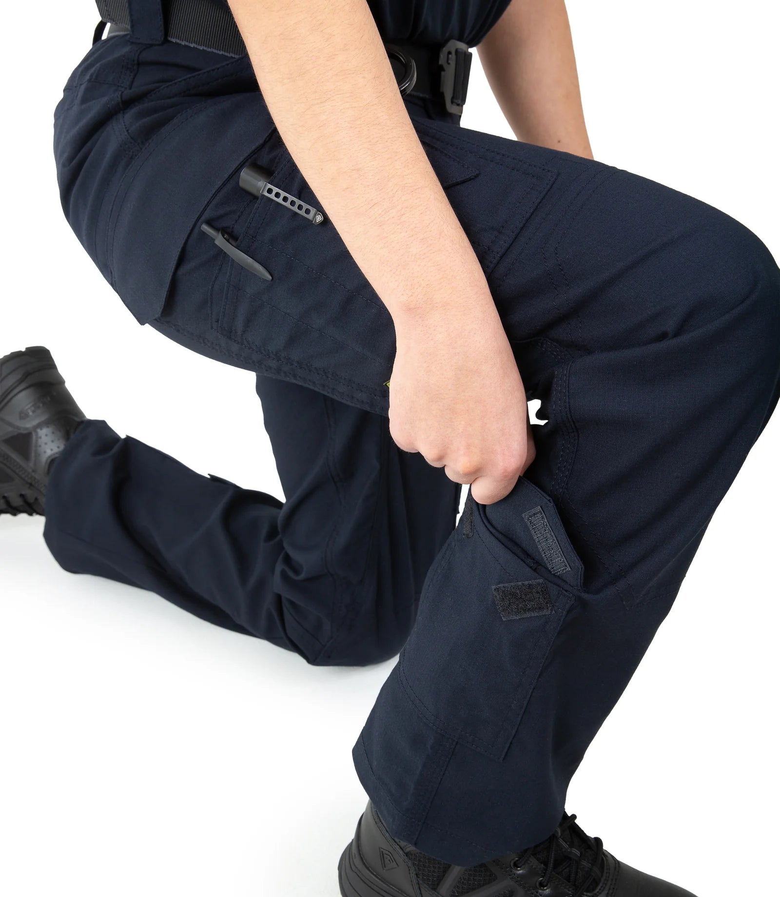 Navy blue tactical pants with multiple pockets on a white background