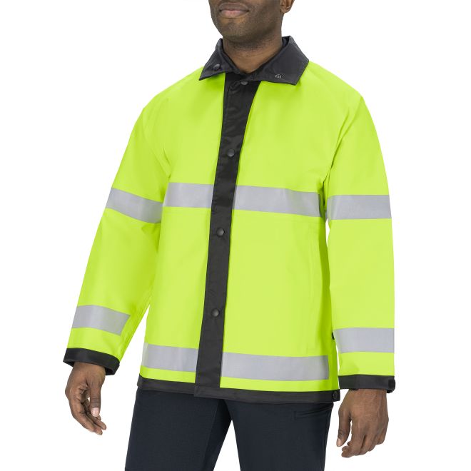 Person wearing a bright yellow safety jacket with reflective stripes on a white background