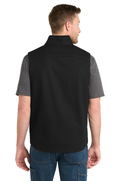 Man wearing a black vest over a gray shirt on a white background