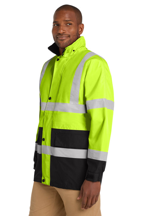 Man wearing a high-visibility yellow and black jacket with reflective stripes on a white background