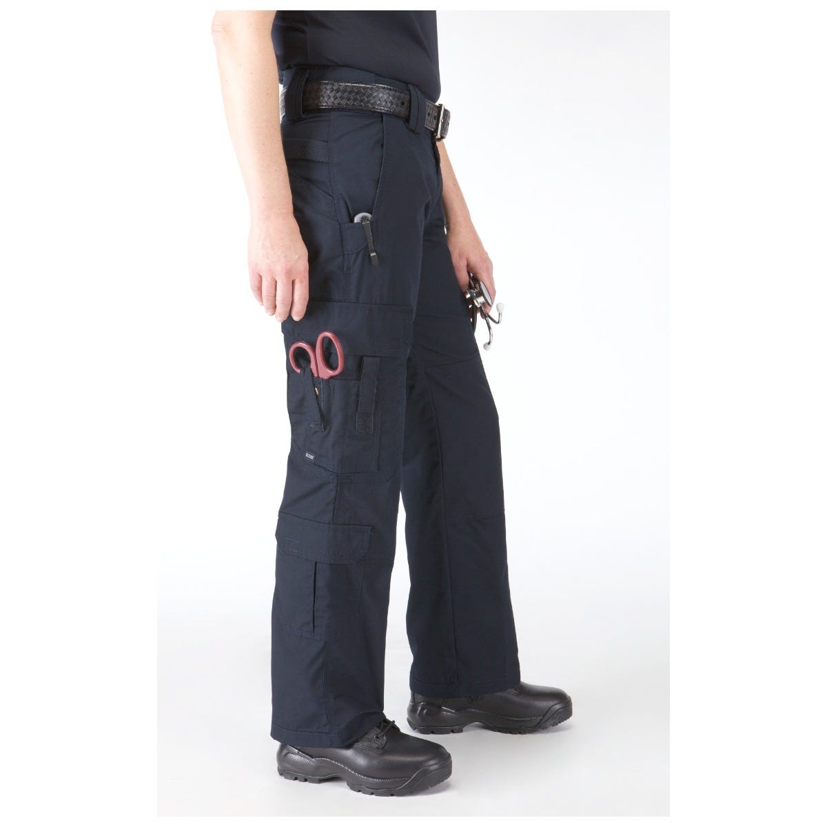 Person wearing black tactical pants with visible branding on a white background