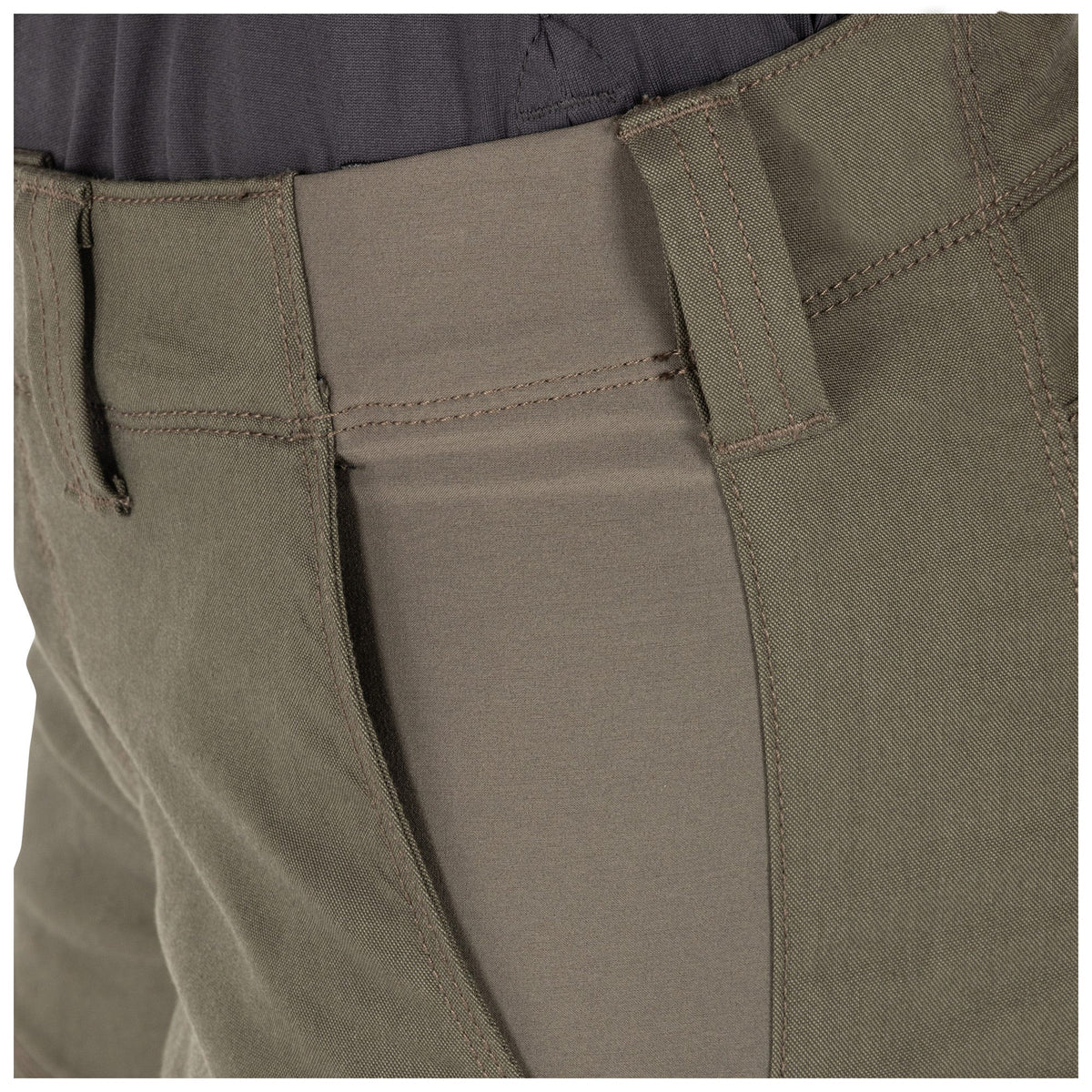 Close-up of olive green pants with a focus on the fabric texture and stitching.