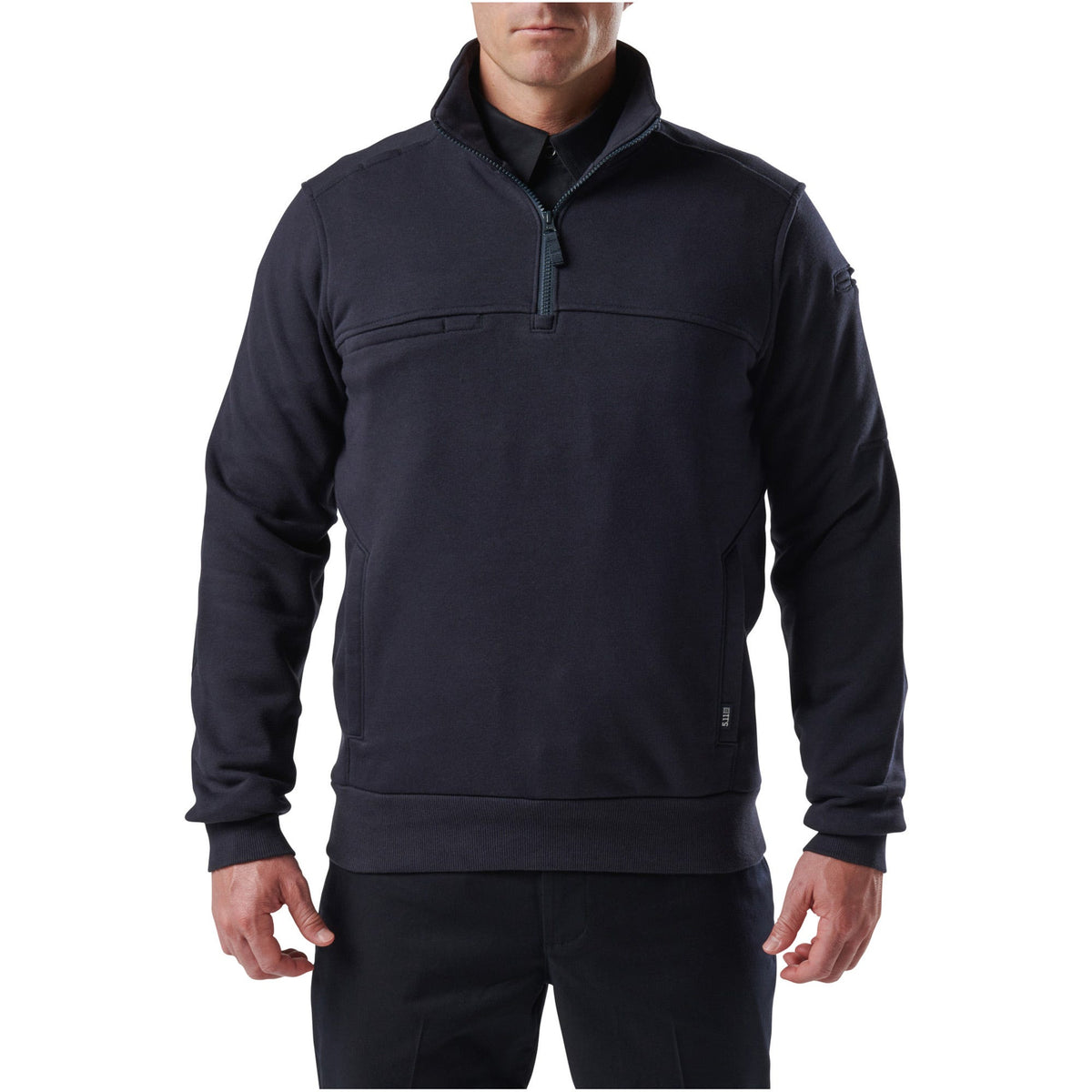 Man wearing a dark gray pullover with a quarter-zip design on a white background