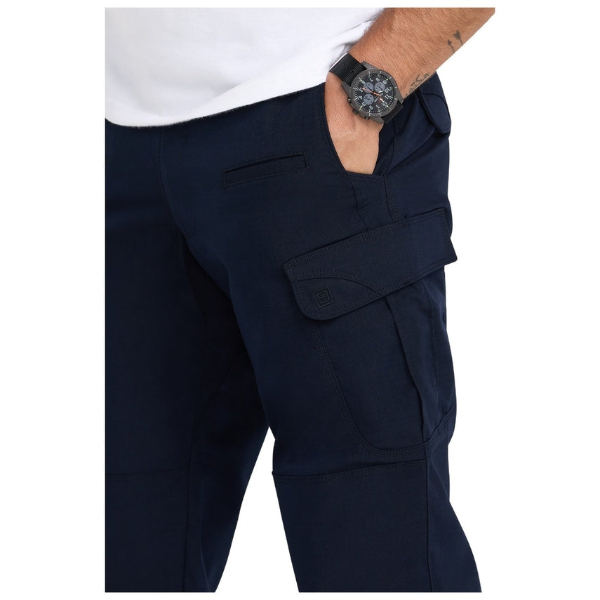 Navy cargo pants with a white shirt and black watch on a white background