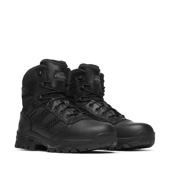 Pair of black tactical boots on a white background