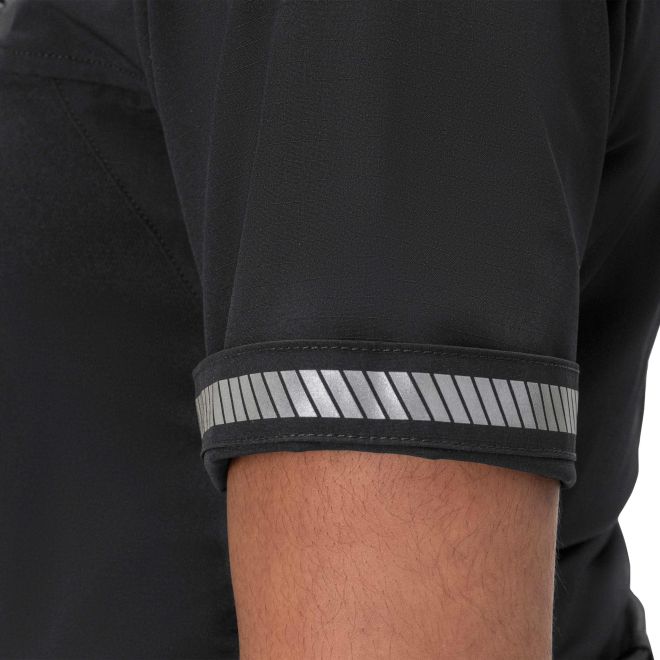 Close-up of a black sleeve with reflective silver stripes on a plain background