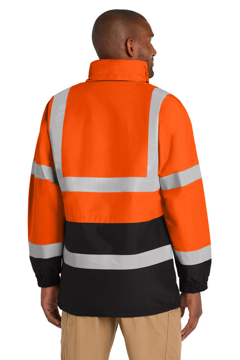 Person wearing an orange and black high-visibility jacket with reflective stripes on a white background