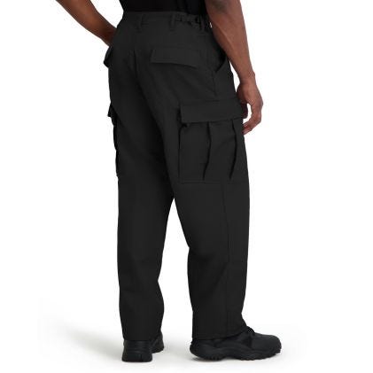Black tactical pants worn by a person on a white background