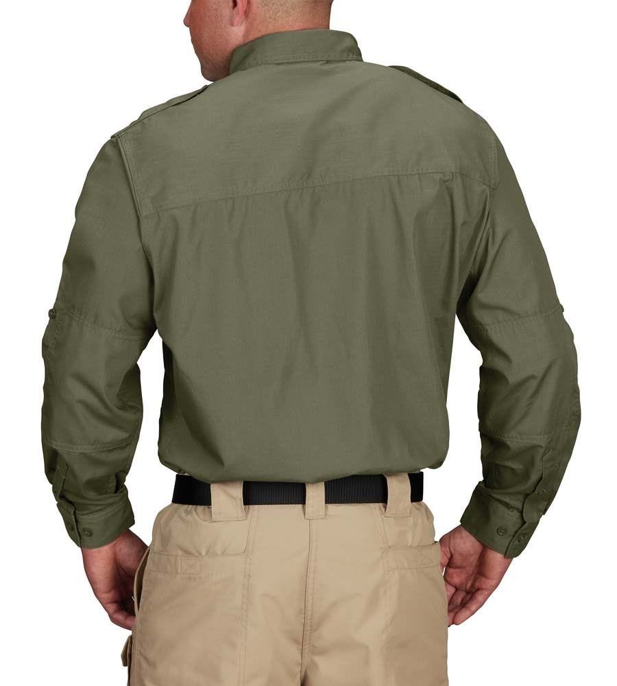 Person wearing a green shirt and beige pants on a white background