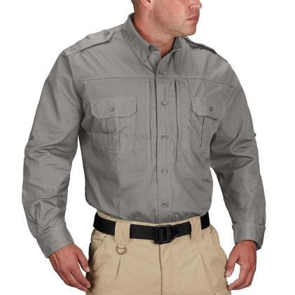 Man wearing a gray long-sleeve shirt and beige pants on a white background