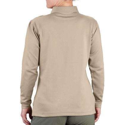 Beige long-sleeve shirt worn by a person on a white background