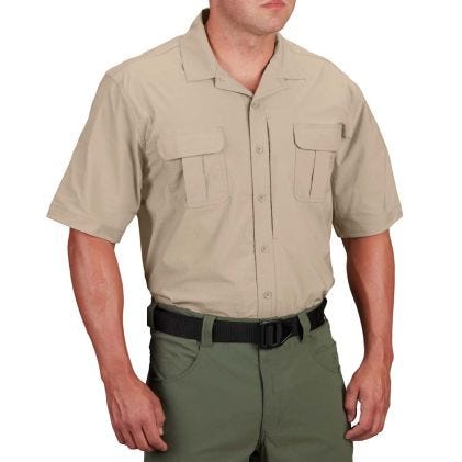 Man wearing a beige short-sleeve shirt and green pants on a white background