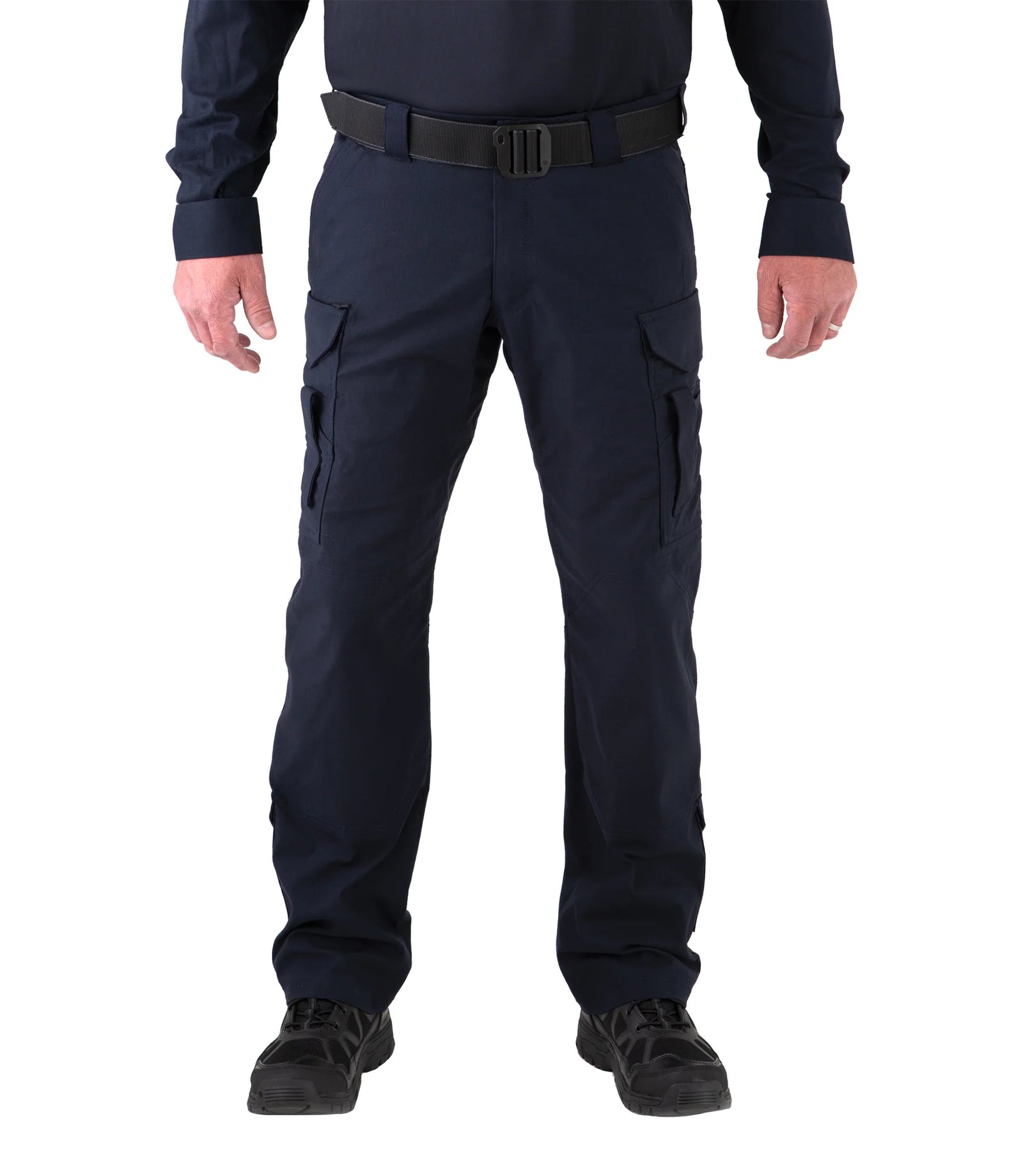 Person wearing navy blue cargo pants on a white background