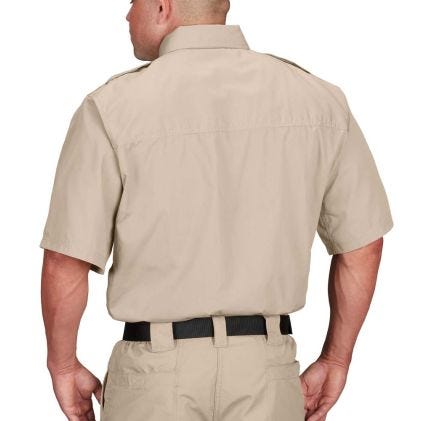 Person wearing a beige short-sleeve shirt and pants on a white background