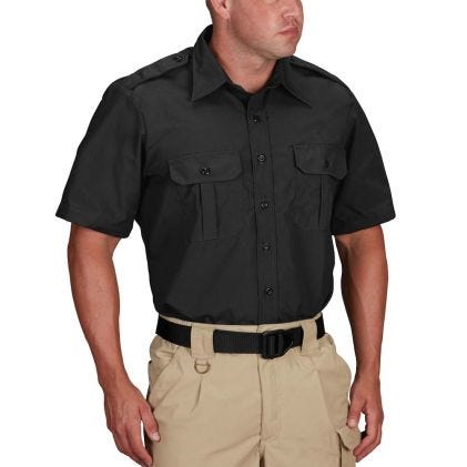 Man wearing a black short-sleeve shirt and beige pants on a white background