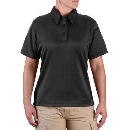 Person wearing a black polo shirt and beige pants on a white background