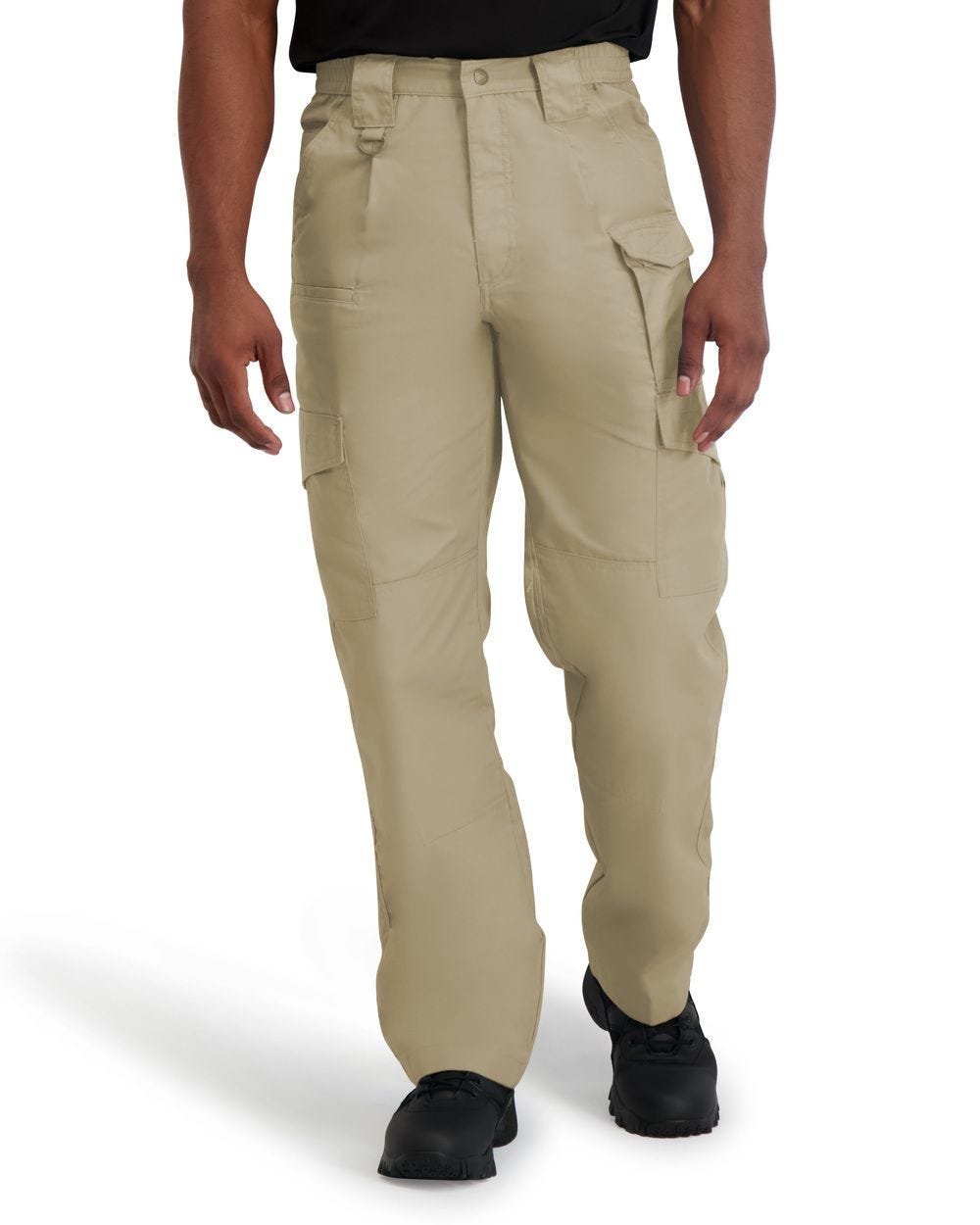 Person wearing beige tactical pants on a white background