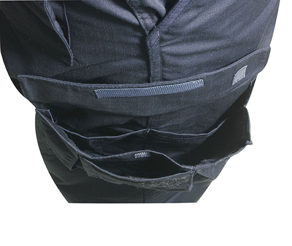 Close-up of a black tactical vest with multiple pockets on a white background