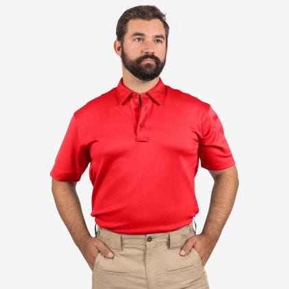 Man wearing a red polo shirt and beige pants on a white background