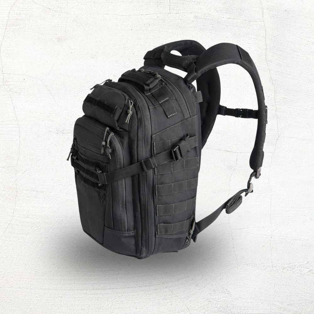 Black tactical backpack on a beige background