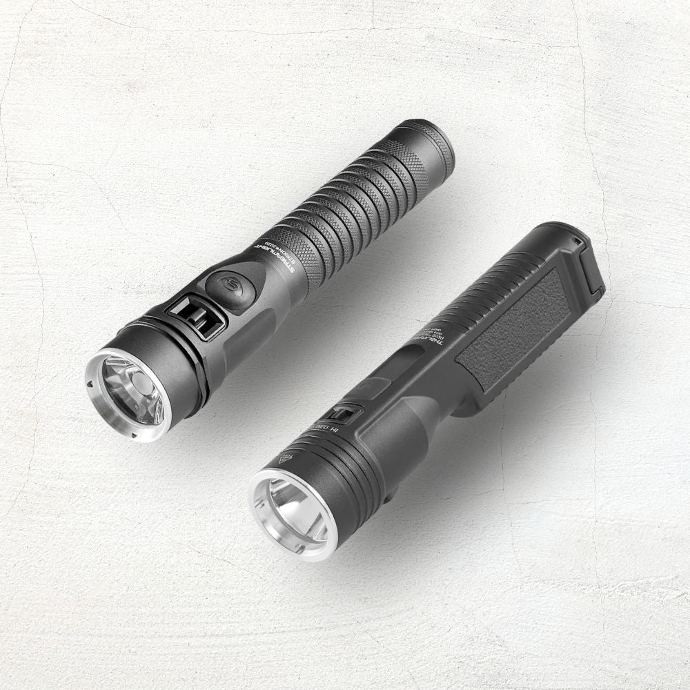 Two black flashlights on a beige background